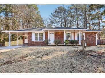 Charming single-story brick home with a covered carport and well-maintained front yard at 8298 Holly Dr, Jonesboro, GA 30238