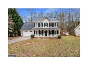 Charming two-story home with a welcoming front porch and attached two-car garage at 128 Brookhaven Ln, Mcdonough, GA 30253