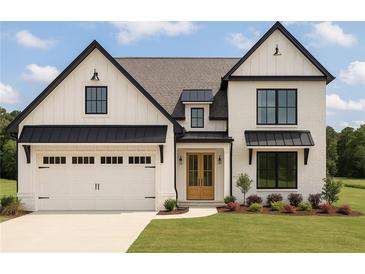 Charming two-story home with modern farmhouse style, painted brick and a well manicured lawn at 500 Level Creek Rd, Sugar Hill, GA 30518
