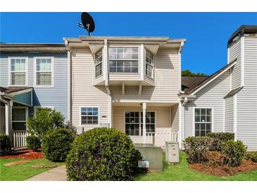 Charming multi-level home with a cozy front porch and manicured landscaping at 5880 Trent Walk Dr, Lithonia, GA 30038