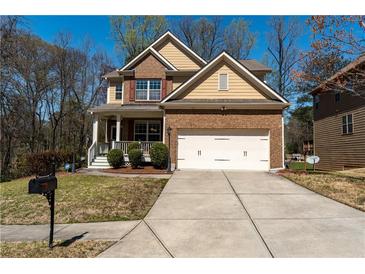 Charming two-story home with a well-manicured lawn and attached two-car garage at 3482 Willow Meadow Ln, Douglasville, GA 30135