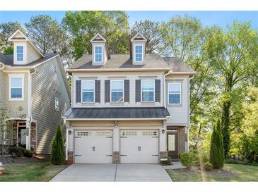 Charming two-story home featuring a two-car garage and neutral siding, with a well-maintained front yard at 3377 Park Pointe Cir, Scottdale, GA 30079