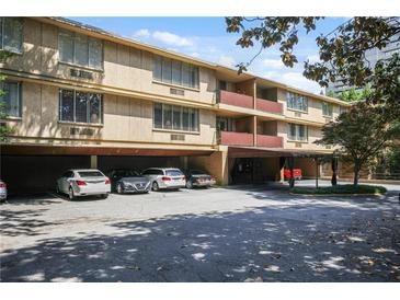 Multi-story condo building with covered parking and balconies in a lush, tree-lined neighborhood at 2637 Peachtree Ne Rd # 407, Atlanta, GA 30305