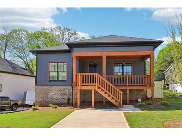 Charming home with a covered porch and brick foundation in a residential neighborhood at 682 Shelton Sw Ave, Atlanta, GA 30310