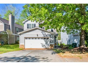 Charming two-story home featuring a two-car garage, stone accents and mature trees in a suburban setting at 206 Cole Ct, Canton, GA 30114