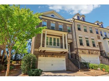 Charming two-story brick townhome featuring a private balcony and an attached two-car garage at 823 Canterbury Overlook, Atlanta, GA 30324
