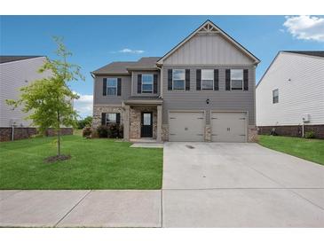 Charming two-story home featuring a two-car garage, well-maintained lawn, and neutral exterior at 1439 Veranda Ln, Mcdonough, GA 30253
