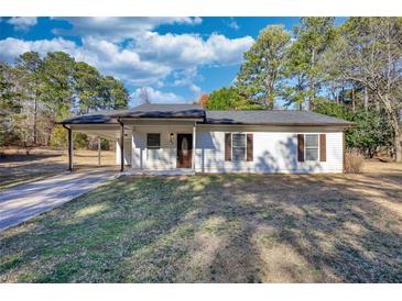 Charming single-story home with a covered carport and a well-maintained front lawn at 61 Andrew Rd, Covington, GA 30016