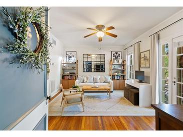 Inviting living room with hardwood floors, area rug, ceiling fan, and an abundance of natural light at 794 Frederica Ne St # 2, Atlanta, GA 30306