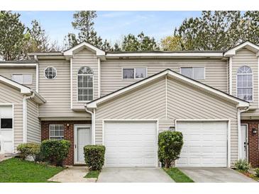 Charming townhouse showcasing a well-maintained facade, brick accents, and a convenient attached garage at 3795 Soapstone Rd, Decatur, GA 30034