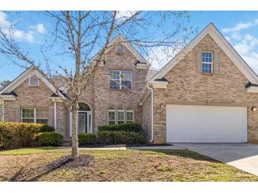Charming brick home with a well-manicured lawn and a two-car garage, providing ample curb appeal at 4114 Bigsage Dr, College Park, GA 30349