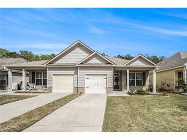 Charming single-story home with a two-car garage and well-maintained lawn at 515 Vandenburg Dr, Villa Rica, GA 30180
