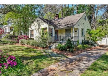 Charming home boasts mature landscaping and a cozy front porch, perfect for relaxing outdoors at 1015 S Candler St, Decatur, GA 30030