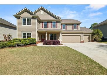 Charming two-story home with a well-maintained lawn and a three-car garage at 2881 Terra View Sw Dr, Lilburn, GA 30047