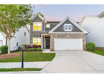 Charming two-story home featuring a brick accent, well-manicured lawn, and attached two-car garage at 3314 Tiara Cir, Atlanta, GA 30311