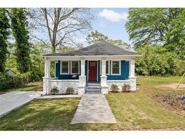 Charming blue cottage with a welcoming front porch and well-manicured lawn at 531 Roy Sw St, Atlanta, GA 30310