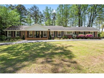 Charming one-story brick home with inviting front porch and well-manicured lawn at 629 Concord Sw Rd, Smyrna, GA 30082