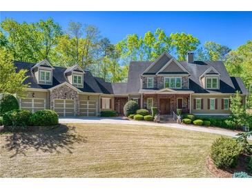 Spacious two-story home featuring a three-car garage and a well-manicured front yard at 1000 Holly St, Canton, GA 30114