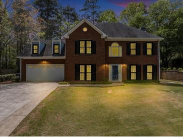 Charming two-story brick home with black shutters, dormer windows, and a well-manicured front lawn at 1960 Barnes Mill Rd, Marietta, GA 30062