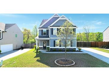 Charming two-story home with stone accents, manicured lawn, and classic architectural details at 269 Shoals Bridge Rd, Acworth, GA 30102