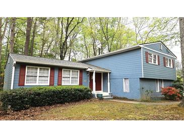 Charming home featuring blue siding, red shutters, and a well-maintained front yard at 2912 Pathview Ln, Marietta, GA 30062