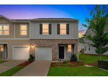 Charming two-story home with brick accents, a well-manicured lawn, and an attached garage at 3541 Condor Ct, Atlanta, GA 30331