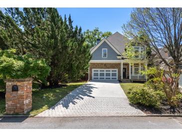 Charming two-story home featuring stone and siding, a two-car garage, and a beautifully landscaped front yard at 1159 Thornwell Ne Dr, Brookhaven, GA 30319