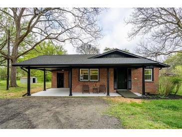 Charming brick home featuring a covered entrance, well-maintained landscaping, and a welcoming facade at 80 E Howard St, Kingston, GA 30145
