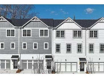 Beautiful townhome showcases multi-tone color, garage, and covered front porch at 1297 Ascot Ter, Atlanta, GA 30329