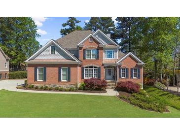 Lovely brick home with well-kept lawn, featuring classic architecture and dark shutters at 6252 Fernstone Trl, Acworth, GA 30101
