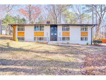 Inviting exterior view of a two-story home featuring painted brick and modern wood accents at 2541 Peyton Woods Sw Trl, Atlanta, GA 30311