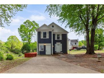 Charming two-story home featuring a well-maintained yard and inviting curb appeal on a sunny day at 1647 Imperial Ct, Norcross, GA 30093