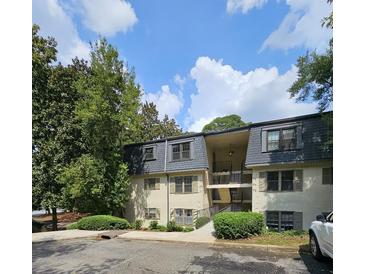 Inviting two-story apartment complex featuring well-maintained landscaping and a private balcony at 173 Amherst Nw Pl, Atlanta, GA 30327
