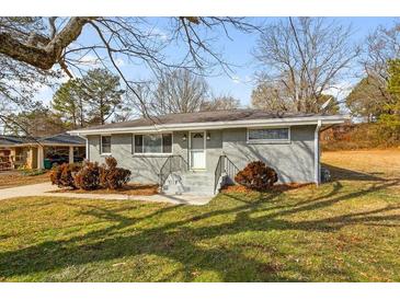 Charming one-story home with grey painted brick, landscaped yard and a welcoming front entrance at 1021 Magnolia Se Dr, Smyrna, GA 30082