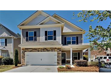 Charming two-story home with stone accents, a two-car garage, and a welcoming covered porch at 156 Crescent Wooode Dr, Dallas, GA 30157