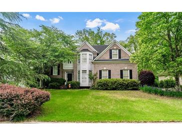 Charming two-story brick home with manicured lawn, mature trees, and a beautiful bay window feature at 1270 Cameron Crk, Marietta, GA 30062