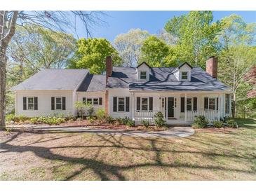 Charming home with a welcoming porch and neatly landscaped front yard, perfect for enjoying the outdoors at 3775 Belle Glade Trl, Snellville, GA 30039