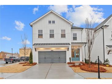 Charming two-story home featuring a two-car garage, complemented by manicured landscaping at 683 Summitt Hill Way, Cumming, GA 30040