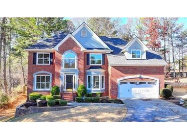Stately two-story brick home with a manicured lawn and attached two car garage at 1081 Talon Trce, Lawrenceville, GA 30043