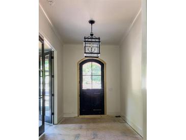 Beautiful foyer with black door and lantern-style light fixture at 2461 Fernleaf Nw Ct, Atlanta, GA 30318
