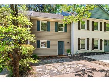 Charming two-story townhouse with tan siding, green shutters, and beautiful stone walkway at 706 Twin Brooks Se Ct, Marietta, GA 30067