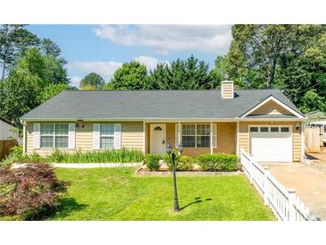 Charming ranch-style home with manicured lawn, white trim, and inviting curb appeal at 1081 Singleton Valley Cir, Norcross, GA 30093