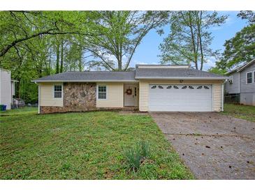 Charming single-story home featuring stone accents and a well-maintained front yard at 1248 Reilly Ln, Clarkston, GA 30021