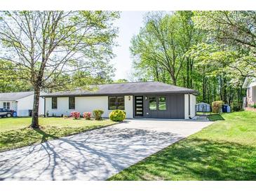 Charming single-story home with a well-maintained lawn and modern front door at 3719 Paul St, Douglasville, GA 30135