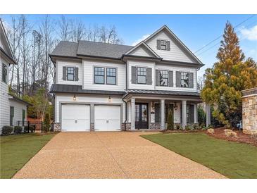 Charming two-story home with a two-car garage and meticulously landscaped front yard at 1010 Coleman Place Dr, Roswell, GA 30075