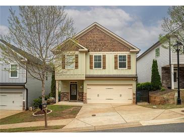 Charming two-story home with a light green exterior, stylish shutters and a two-car garage at 540 Broughton Dr, Canton, GA 30114