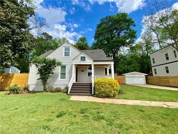 Charming home with a well-manicured front yard, welcoming porch, and beautiful landscaping at 2010 Bixby Se St, Atlanta, GA 30317