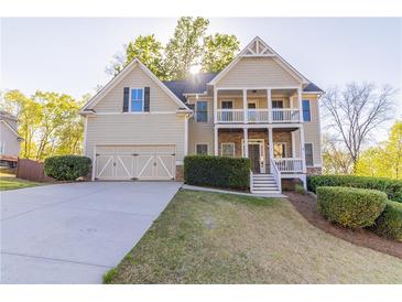 Charming home featuring a welcoming front porch, well-manicured lawn, and convenient two-car garage at 288 Pine Way, Dallas, GA 30157