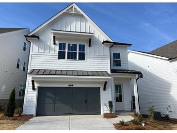 Charming two-story home featuring a gray garage door and a well-manicured front yard at 685 Summitt Hill Way, Cumming, GA 30040