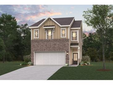 Charming two-story home with a brick and siding exterior, attached garage, and well-manicured lawn at 1020 Sutherland Lane (Lot 41), Lawrenceville, GA 30043